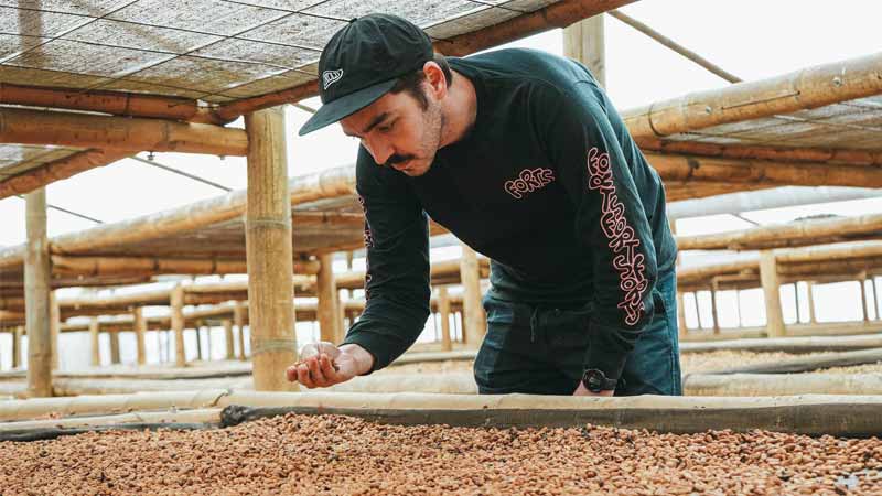 Hard Lines team member with coffee beans